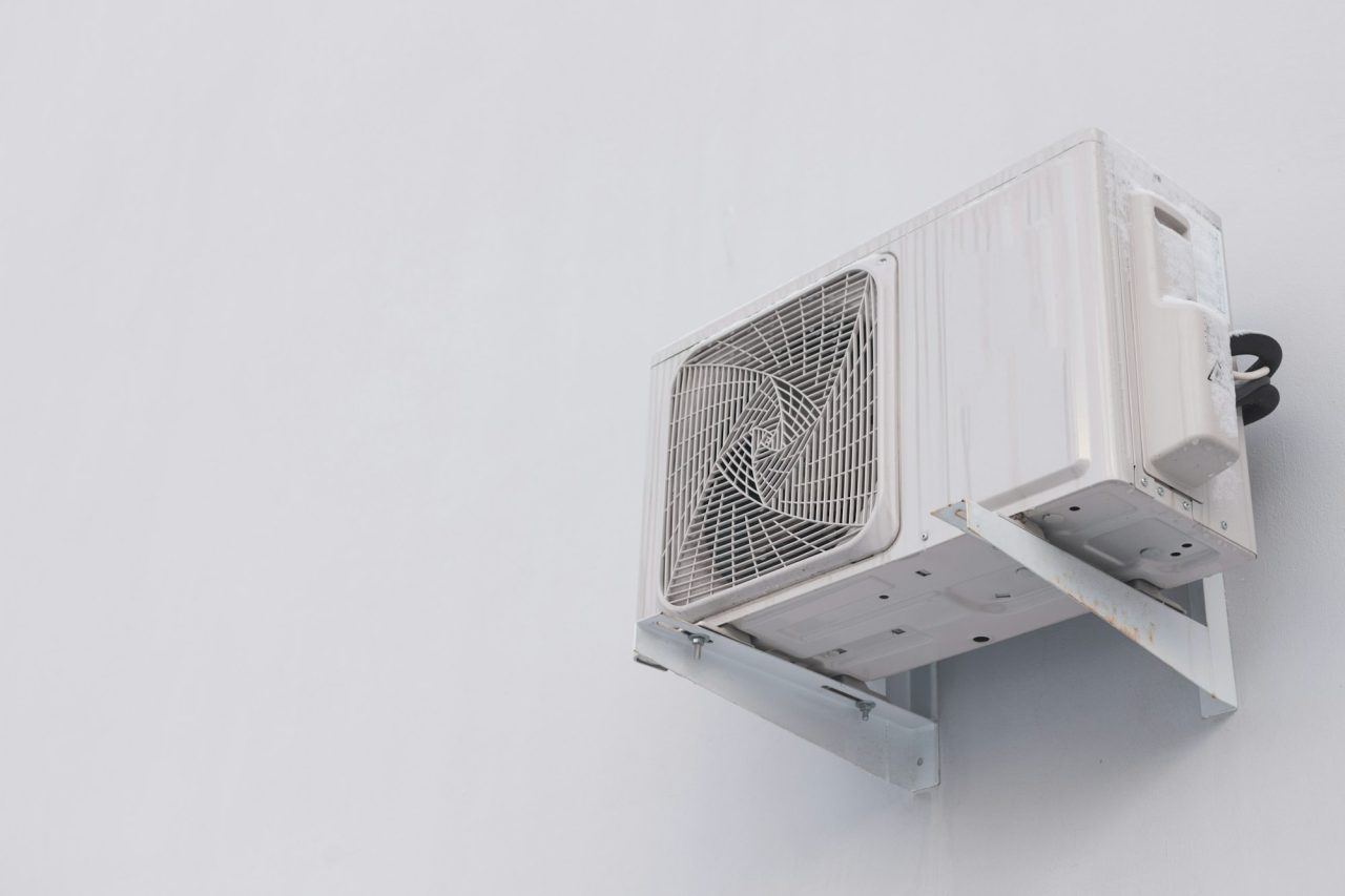 outdoor-air-conditioner-split-system-unit-on-white-wall-with-copy-space